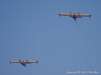 A pair of Canadair  fire-fighting seaplanes arrive.